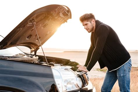 Premium Photo Young Upset Casual Man Trying To Fix His Broken Car