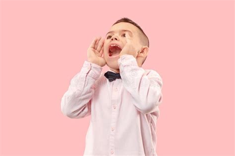 Isolated On Pink Young Casual Boy Shouting At Studio Stock Image