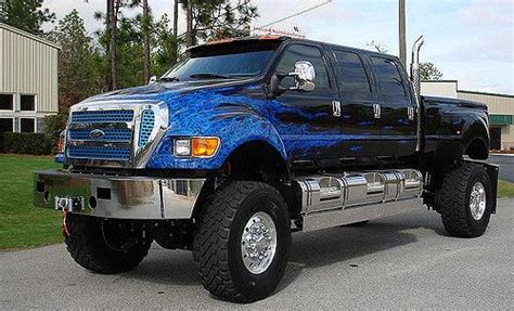 A Blue And Black Truck Parked In Front Of A Building