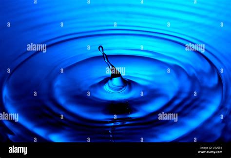 Water Droplet With Blue Ripples Stock Photo Alamy