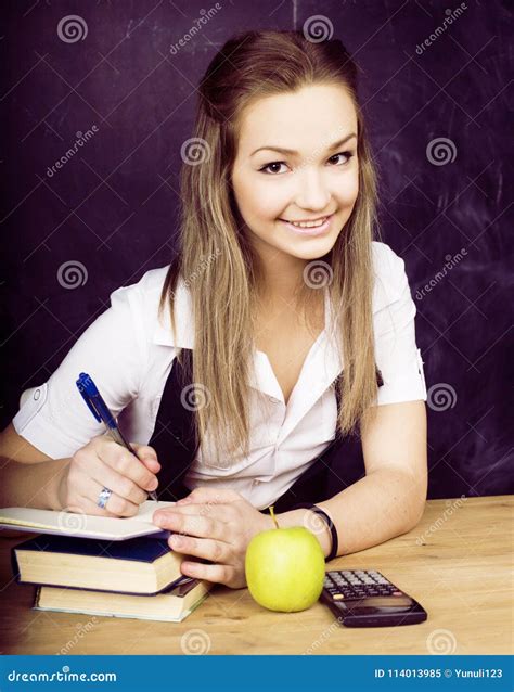Portrait Of Happy Cute Student With Book In Classroom Stock Image