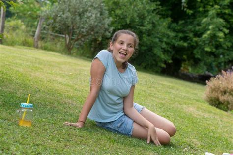Young Teenager Girl Sitting In The Grass Stock Image Image Of