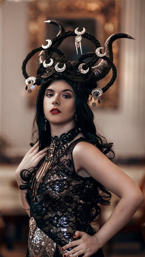 A Woman With Horns On Her Head Wearing A Dress