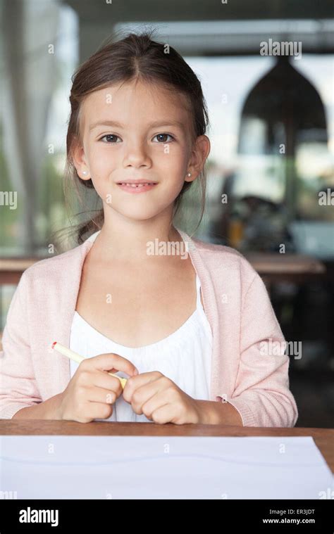 Little Girl Sitting With Pen And Paper Portrait Stock Photo Alamy