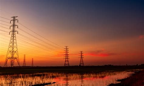 High Voltage Electric Pylon And Electrical Wire With Sunset Sky