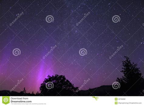 Purple Aurora Borealis Or Northern Lights With The Milky