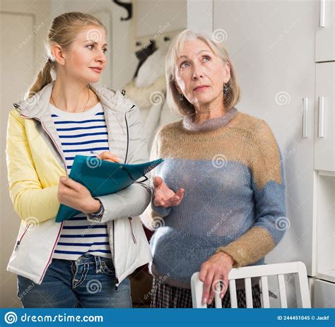Mature Woman Answers Questions Of Interviewer At Home Stock Image
