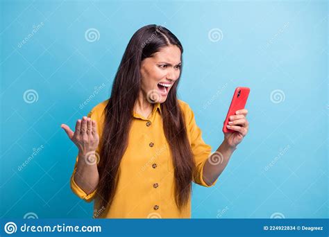 Portrait Of Displeased Lady Staring Phone Open Mouth Yell Loud Bad Fake News Isolated On Blue