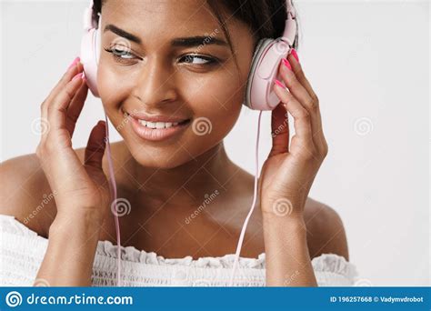 Image Of African American Woman Listening To Music With Headphones