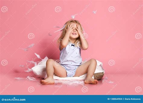 Beautiful Little Girl Sitting On Pillow Studio Shot Stock Photo
