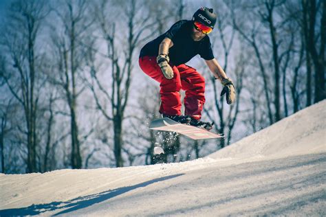 Man Riding On Snowboard In Mid Air Jump · Free Stock Photo