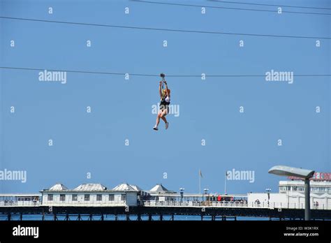 A Lady Zip Wiring In Brighton Stock Photo Alamy