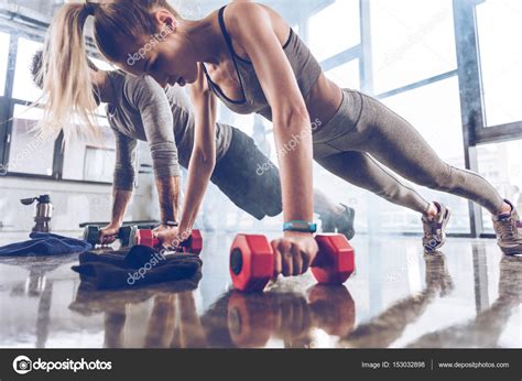 Sporty People Exercising In Gym Stock Photo By ©arturverkhovetskiy