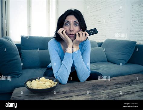 Lifestyle Portrait Of Young Woman Feeling Scared And Shocked Holding Her Head In Amazement While