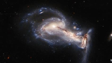 Hubble Captures A Spectacular Three Way Gravitational Tug Of War