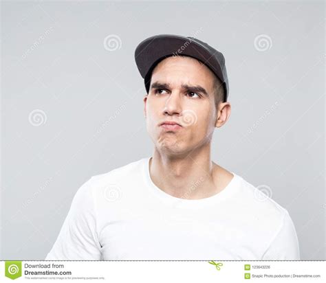 Portrait Of Uncertain Young Man In Baseball Cap Stock Photo Image Of