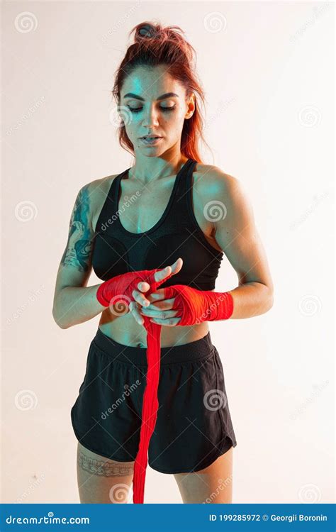 Portrait Of Cool Girl Fighter Putting On Boxing Bandages Stock Photo