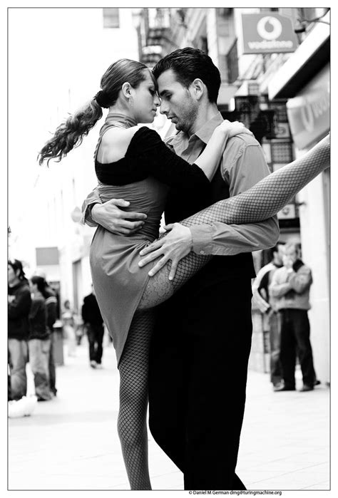 A Man And Woman Dancing On The Street