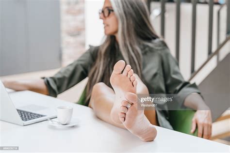 Woman Working In Office With Bare Feet On Desk Photo Getty Images