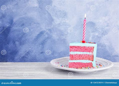 Slice Of Fresh Delicious Birthday Cake With Candle On Table Against