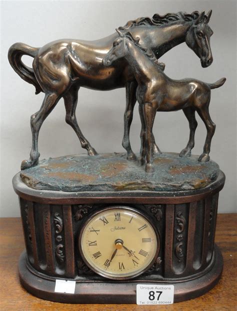 A Mantel Clock Surmounted Horse With Foal