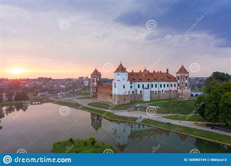 Mirsky Castle And Its Reflection In The Lake In Summer Sunset In