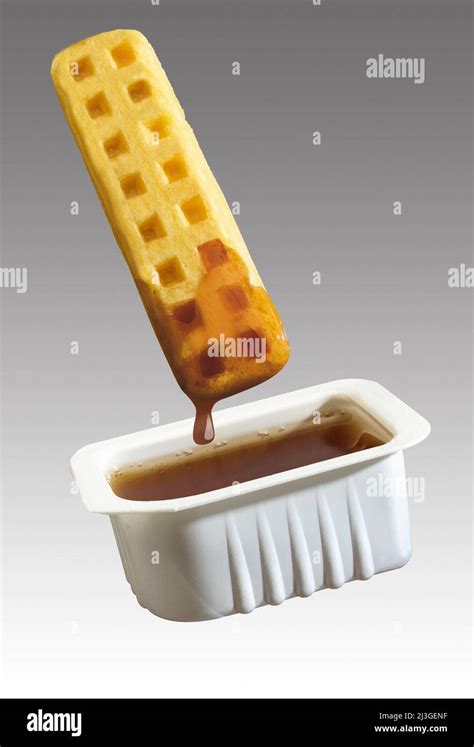 Waffle Stick Dipped In Syrup Stock Photo Alamy