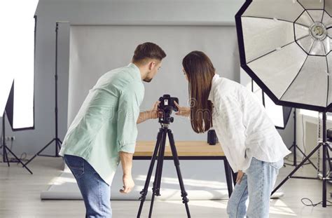 Team Of Two Young Professional Photographers Taking Photos In Their