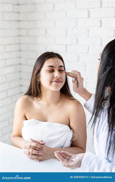 Two Beautiful Women Applying Facial Cream Doing Spa Procedures Stock Image Image Of Body