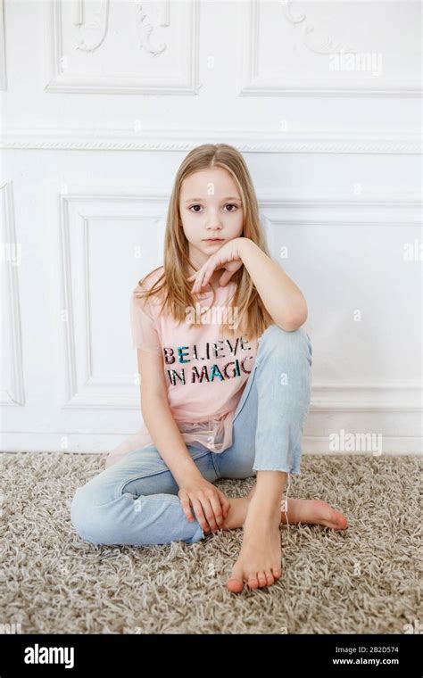 Cute Pre Teen Girl Wearing Fashion Clothes Posing In White Interior