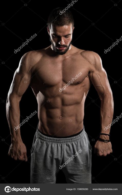 Muscular Athlete Flexing Muscles On Black Background — Stock Photo