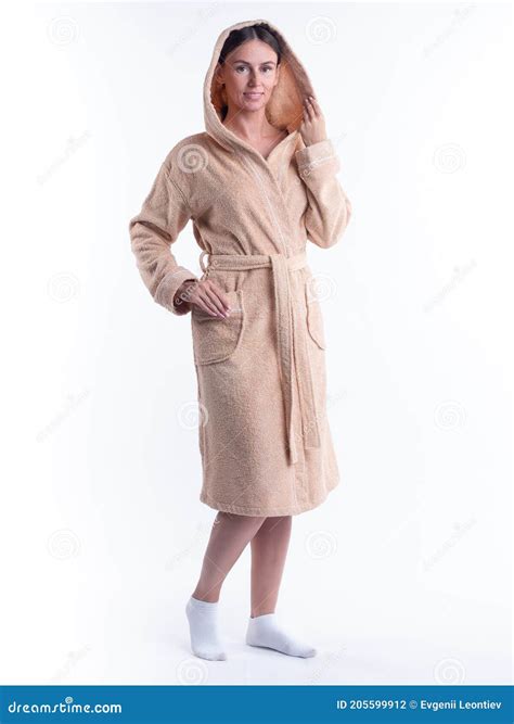 Woman In A Bathrobe On An Isolated White Background With A Smile On Her