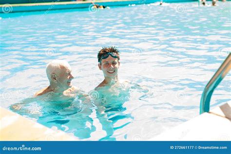 Sports Grandfather And Grandson Communicate In Swimming Pool Stock