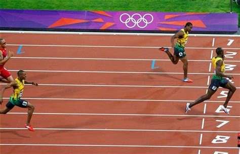 Jamaicas Usain Bolt Crosses The Finish Line And Wins The Mens 200m Final Ahead Of Compatriot