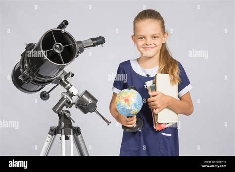 Girl Astronomer Is A Telescope With A Globe And Books In The Hands