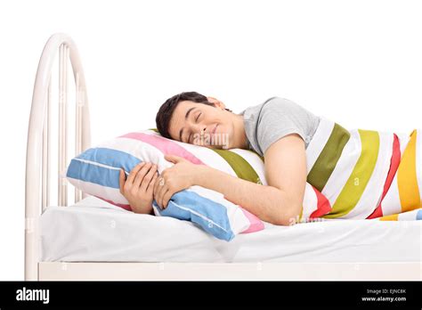 Young Joyful Man Sleeping In A Comfortable Bed And Dreaming Sweet