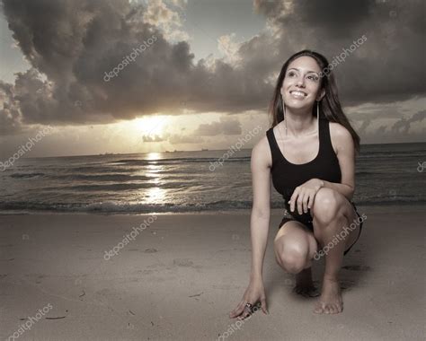 Woman Kneeling On The Sand Stock Photo Felixtm 2589222