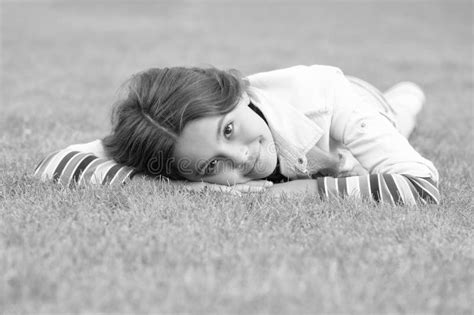 Teenage Girl Relaxing On Green Grass Outdoors Relaxation Stock Image