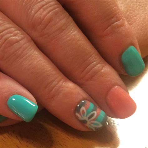 Where to put rhinestones on a teal nail? Teal, coral and grey gel polish with a striped accent nail ...