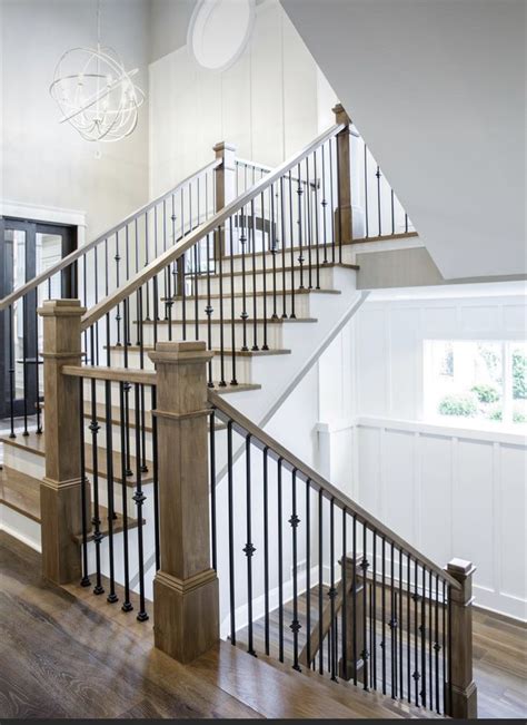 A Stair Case In A Home With Wood Floors And White Walls Along With A