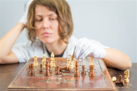 Young Woman Nurse Doctor Playing Chess Checkmate Thinking Game Pieces