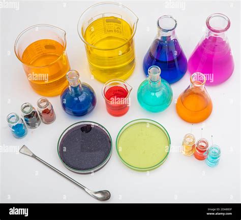 Laboratory Glassware With Liquids Of Different Colors On White Table Volumetric Laboratory