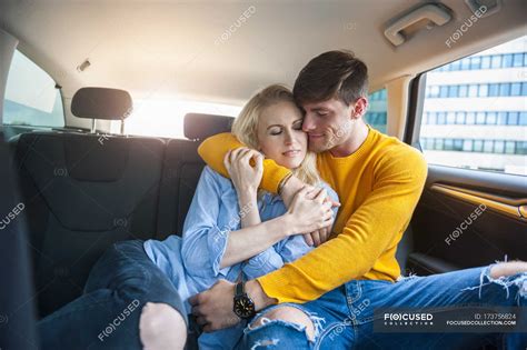 Couple In Love Cuddling On Back Seat Of A Car Togetherness Male