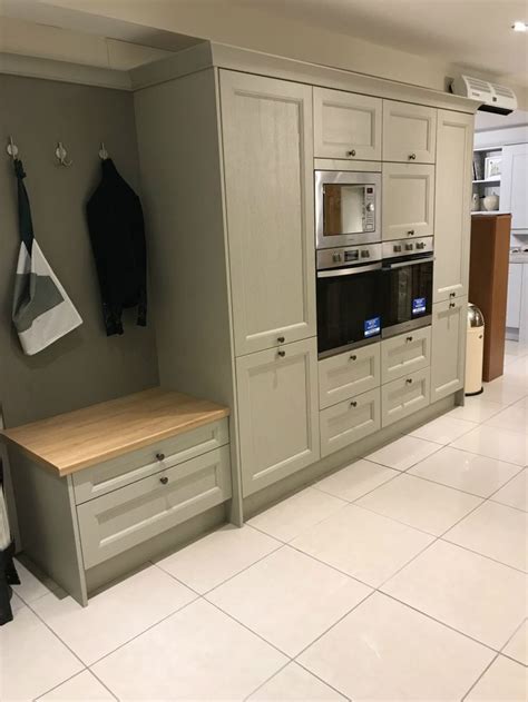 A Kitchen With An Oven Counter And Cabinets In White Tile Floored Room