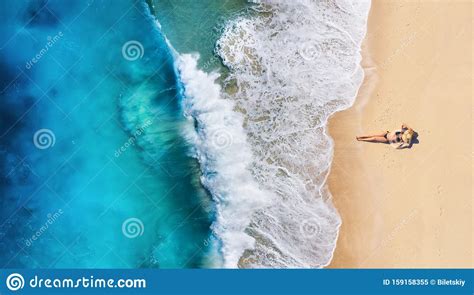 Aerial View Of A Girl On The Beach Beach And Turquoise Water Top View From Drone At Beach