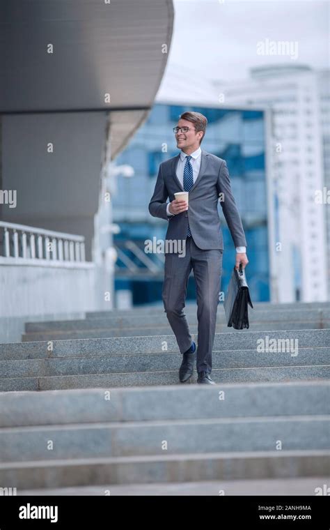 Business Man Walking Down The Street Of A Big City Stock Photo Alamy
