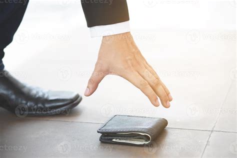 Close Of A Person Picking Up A Lost Wallet On The Ground 7663988 Stock