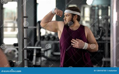 Funny Fat Man Looking At Mirror Reflection Gym And Posing Pretending