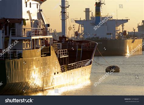 Oiltanker Docking In A Harbour During Sunset Stock Photo 147588461