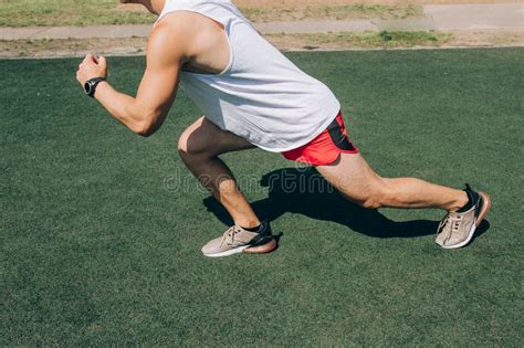 Runner Man Getting Ready To Run Doing Warm Up Dynamic Leg Stretch